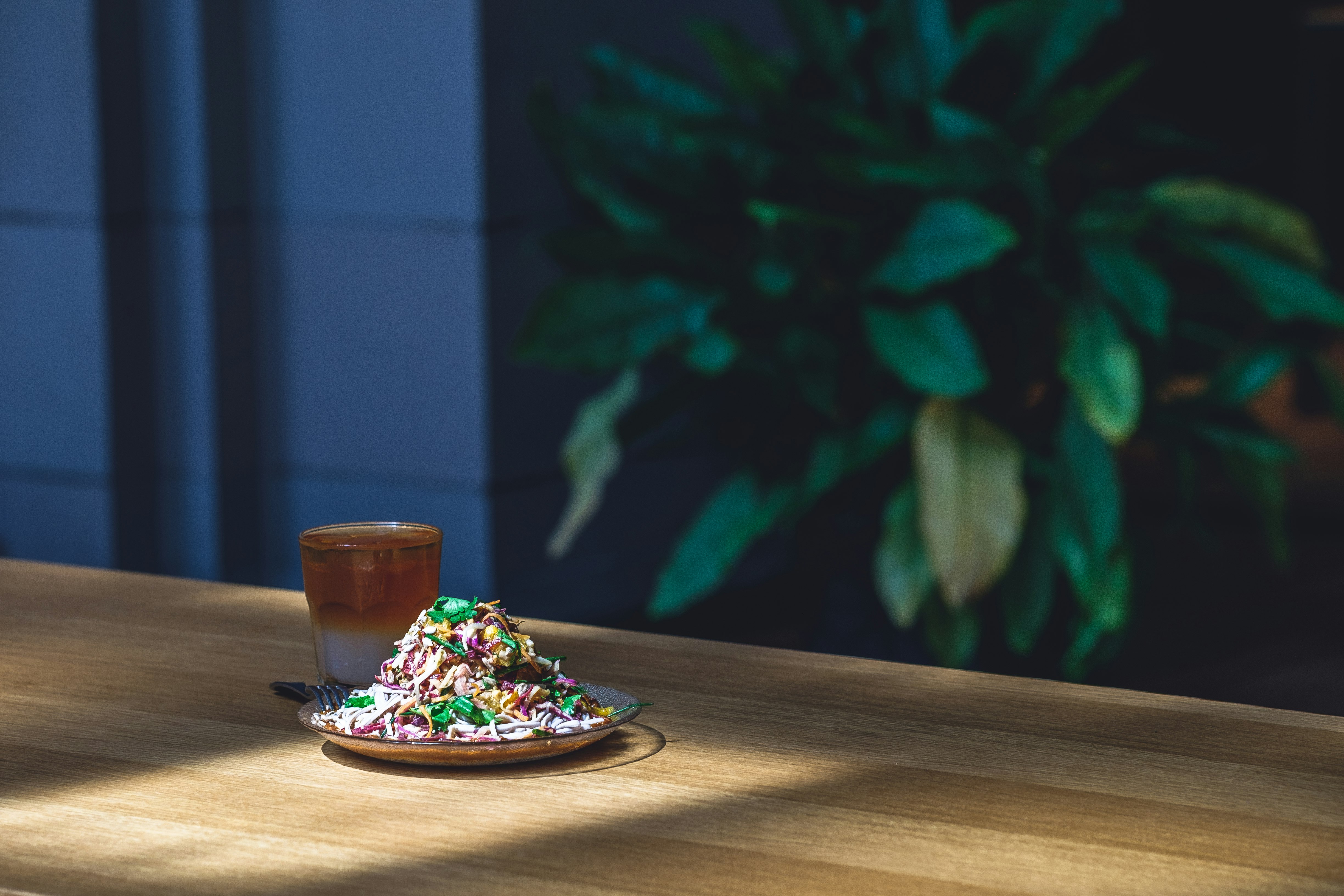 selective focus photography of dish on plate beside mug